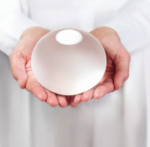 doctor holding a gastric balloon