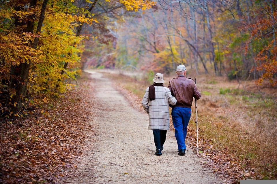 elderly couple active outside walking