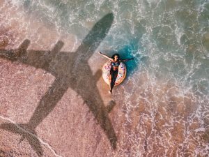woman relaxing in the water with the shadow of an airplane flying over her.