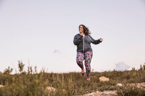 lady happily running outdoors
